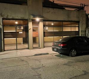 a black car parked in front of a building at Dpto Hipólito Yrigoyen in Concordia