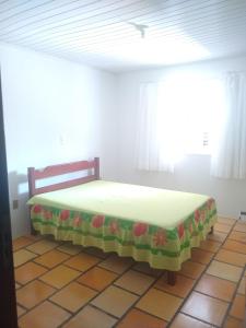 una camera con un letto in una stanza con una finestra di Casa ampla a 50metros do mar a Balneário Barra do Sul
