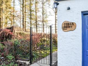 a gate with a sign that reads gun yard liberty at Cowar Bothy in Haugh of Urr