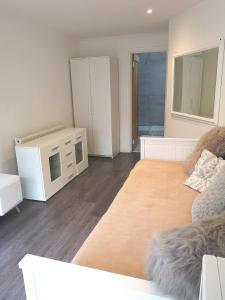 a living room with a couch and a microwave at New COSY HOMES in Newhaven