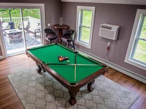 a room with a pool table in a house at Ride from this Mini Mansion to all the ATV Trails in Berlin