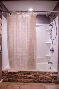 a bathroom with a shower curtain and a tub at Ride from this Mini Mansion to all the ATV Trails in Berlin +25 photos