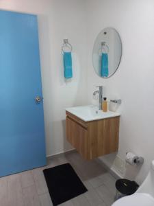 a bathroom with a sink and a mirror and a toilet at CABAÑA EN ISLA FRENTE A CARTAGENA in Cartagena de Indias