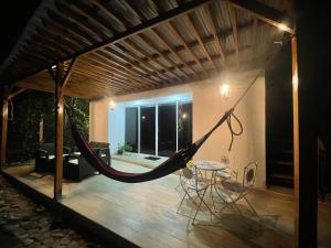 a porch with a hammock in a house at CABAÑA EN ISLA FRENTE A CARTAGENA in Cartagena de Indias