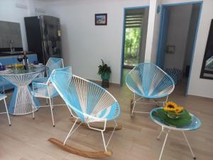 a group of chairs and a table with a bowl of flowers at CABAÑA EN ISLA FRENTE A CARTAGENA in Cartagena de Indias