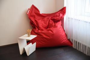 a red pillow sitting on the floor next to a table at Grand Vienna City Center Apartment in Vienna