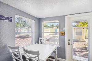 a dining room with a white table and chairs at C4-Octopus in St. Pete Beach