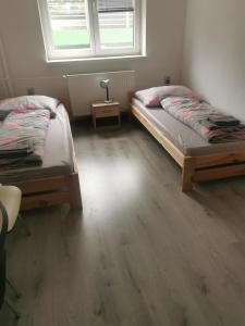 a bedroom with two beds and a window at Living Bratislava &Mlynské Nivy& Bus station in Bratislava