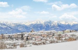 a town covered in snow with mountains in the background at Stunning Apartment In Vason With Kitchen in Vason