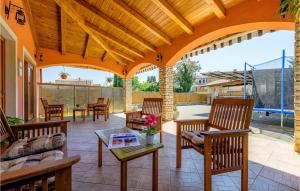 an outdoor patio with chairs and a table with a table at 3 Bedroom Amazing Home In Smoljanci in Smoljanci