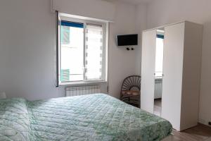 a bedroom with a bed and a window and a television at Casa Pietro e Bea in Rapallo