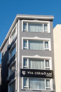 a tall gray building with a sign on it at Via Çırağan Hotel in Istanbul