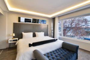 a bedroom with a large bed and a large window at Via Çırağan Hotel in Istanbul