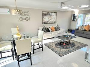 a living room with a couch and a table at Modern Luxury 2-bedroom 2.5-bathroom townhouse in Negril