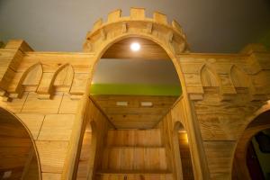 a wooden building with an archway in a room at Godwill Casa Varca in Varca