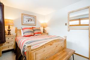 a bedroom with a wooden bed with two lamps and a window at 3614 Winterberry in Wilson