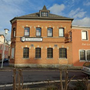 a red brick building with a clock on it at Selb Ferienwohnungen in Selb