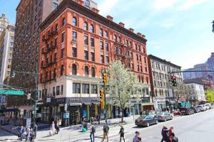 un grupo de personas cruzando una calle frente a un edificio en Park Side Living, Get Cozy!, en Nueva York
