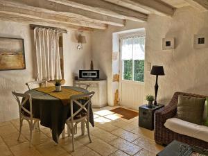 a living room with a table and a couch at Hameau Du Sentier Des Sources in Sarlat-la-Canéda