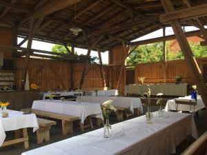 a banquet hall with white tables and benches in it at Altes Kommandeurhaus in Werben an der Elbe in Werben