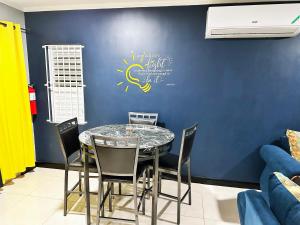 a dining room with a table and chairs at Luxury Crib 5 mins from the NMIA airport in Kingston
