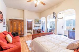 a bedroom with a bed and a couch at Rustic Studio walking distance to Downtown in Reno