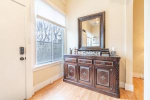 a mirror and a dresser in a room with a window at Rustic Studio walking distance to Downtown in Reno