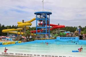 a water park with people in the water at White Sand Getaway steps from Beach in Gulfport