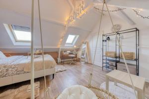 ein Schlafzimmer mit einem Bett und einem Schreibtisch in einem Zimmer in der Unterkunft Duplex les Oiseaux du Verger, au coeur de la ville in Verneuil-sur-Seine