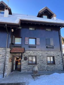 a stone building with a door and windows at Zoncolan Rifugio Laugiane 1616 in Sùtrio