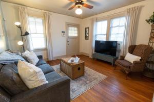 a living room with a couch and a tv at Historic Revival Midtown Memphis Duplex 64 Yes Pets Fast Wifi Free Parking in Memphis