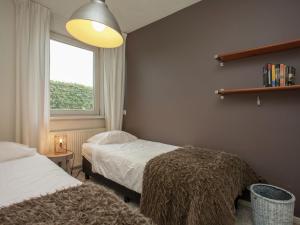 A bed or beds in a room at Majestic, large holiday home near Leende, detached and located between meadows and forests