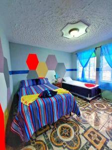 una camera con un letto in una stanza con di Alojamiento San Juan a San Juan La Laguna