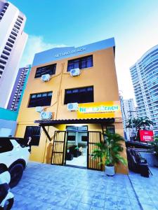 a building with a car parked in front of it at Netuno Beach Hotel in Fortaleza