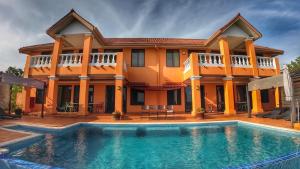 a house with a swimming pool in front of it at Boca Chica Bay Eco Lodge in Boca Chica