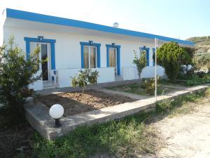 a blue and white house with a street light in front of it at Matina Studios in Kefalos