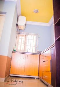 a bathroom with a sink and a toilet in a room at Dayspring Apartments. Entire house for guests. Ekiti in Ado Ekiti