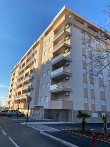 a large apartment building on the side of a street at Apartman Dedijer in Trebinje