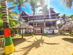 a resort with palm trees and a building on the beach at Hotel Boutique El Mirador in Arboletes