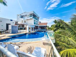 a view of the pool from the balcony of a house at Hotel Boutique El Mirador in Arboletes