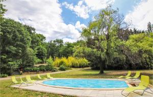 a swimming pool with lawn chairs and a tree at Beautiful Home In Goult With Private Swimming Pool, Can Be Inside Or Outside in Goult