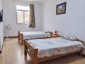 a bedroom with two beds and a window at Casa Talara in Talara