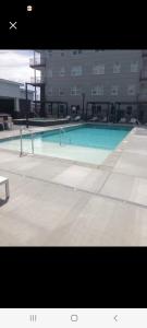 a large swimming pool in front of a building at Modern Downtown SLC Apartment in Salt Lake City