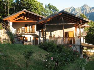a small house with a porch and a balcony at Joy Center - Casa e Appartamenti Vacanza in Val Pellice in Villar Pellice