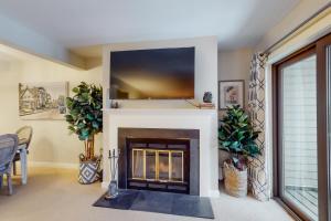 a living room with a fireplace with a flat screen tv at Mountain's Edge in Brownsville