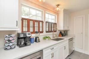 a kitchen with white cabinets and a counter top at Stylish 3 bedroom home close to downtown Mobile in Mobile