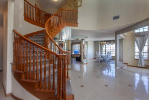 a wooden staircase in a home with a living room at LUXURIOUS VILLA FOR BEST VACATIONS AND MEMORIES in Palmdale