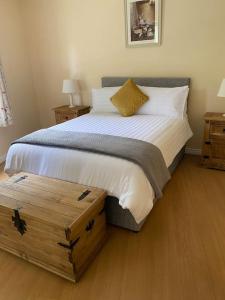 a bedroom with a large bed and two night stands at Glengesh Court. Ardara town centre. in Ardara