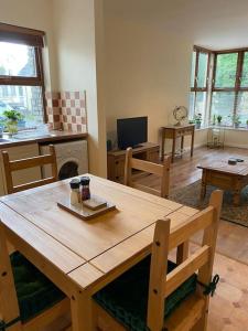 a living room with a wooden table and chairs at Glengesh Court. Ardara town centre. in Ardara