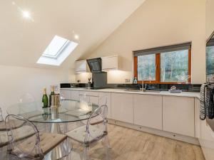 a kitchen with a glass table and chairs and a sink at Waterside Lodge Four - Uk36706 in Southowram